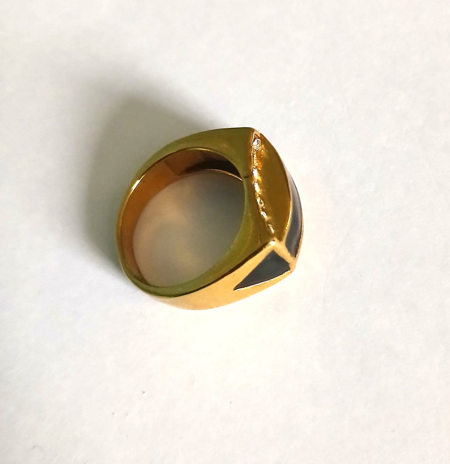 Unique Men's Statement Ring with a Bold Black Gemstone Set in a Gold-Colored Band.