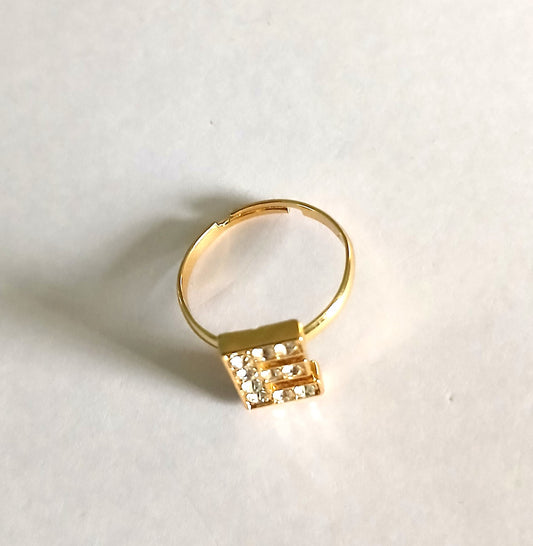 Gold Boho-Style Ring with Letter "E" and Shining Small Gemstones in a Rich Silver Color.