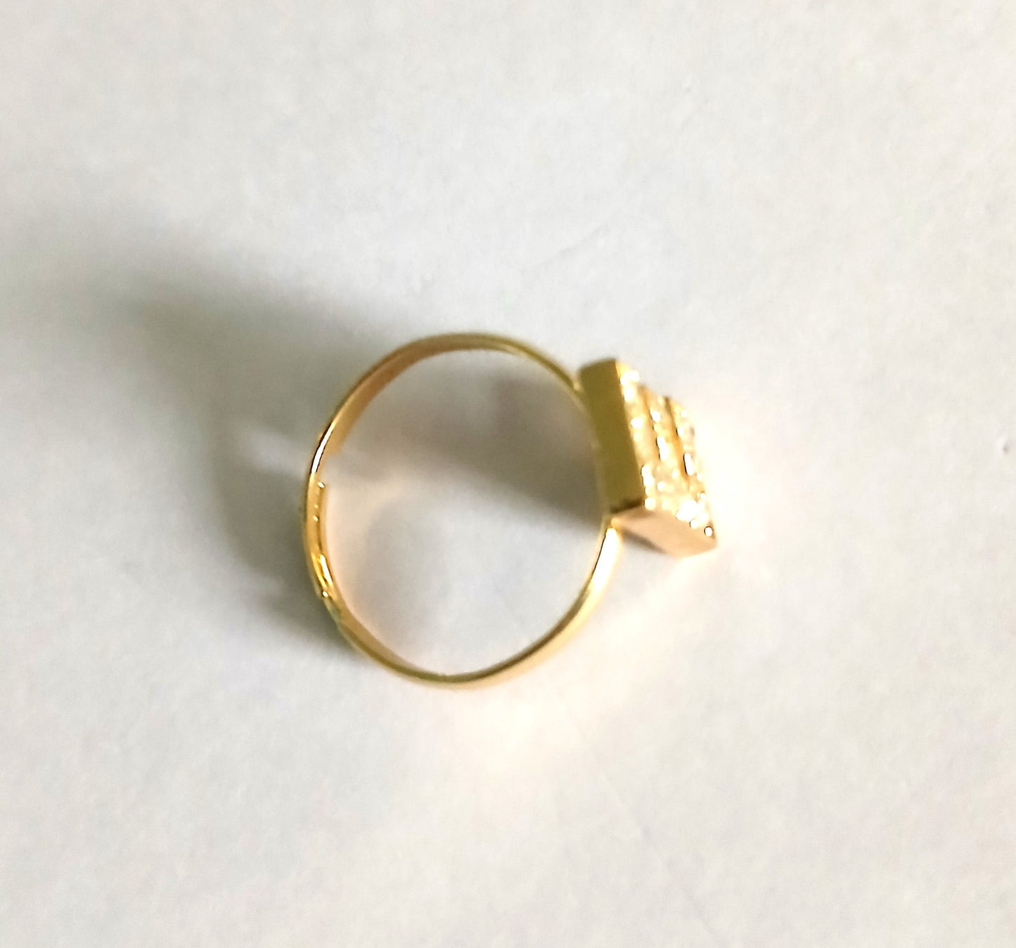 Gold Boho-Style Ring with Letter "E" and Shining Small Gemstones in a Rich Silver Color.