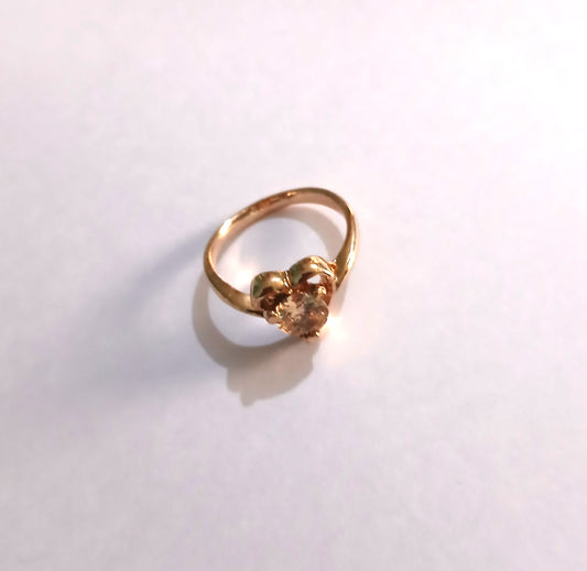 Gold-Colored Ring with a Heart-Shaped Design with a Sparkling Topaz Gemstone.