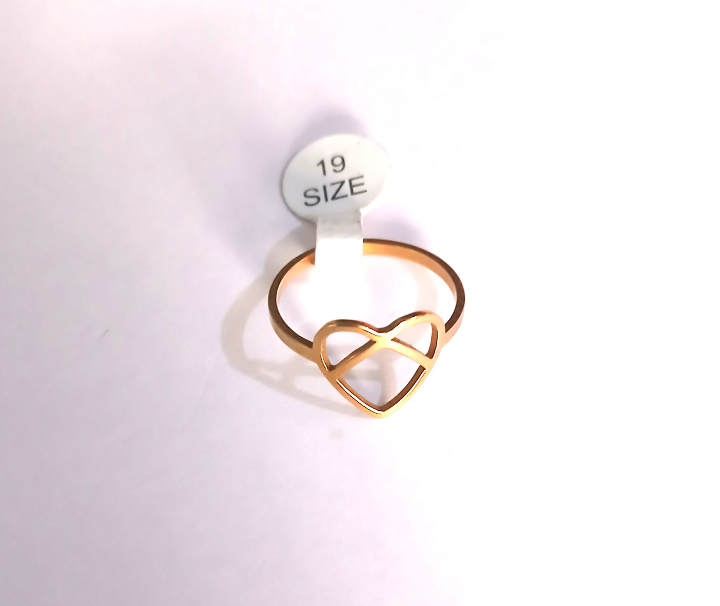Gold heart-shaped ring on a white background with a size label.