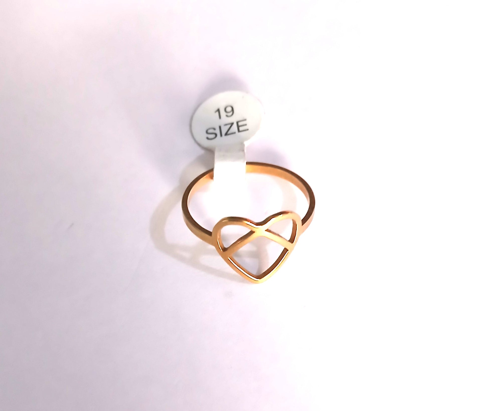 Gold heart-shaped ring on a white background with a size label.